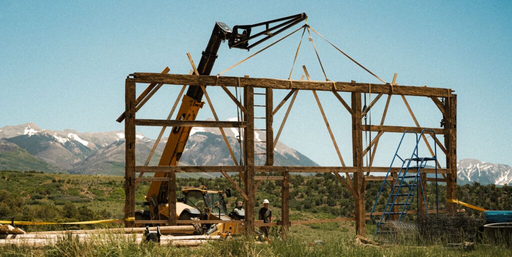 Three Ten Timber raising hand-hewn timber frame in the mountains near Moab, Utah